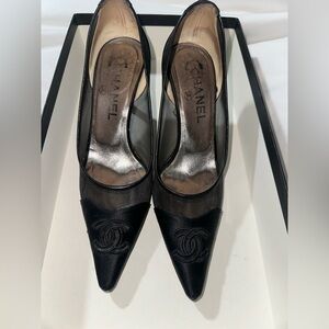 Black satin Chanel pointed heels / used condition , redid the soles .